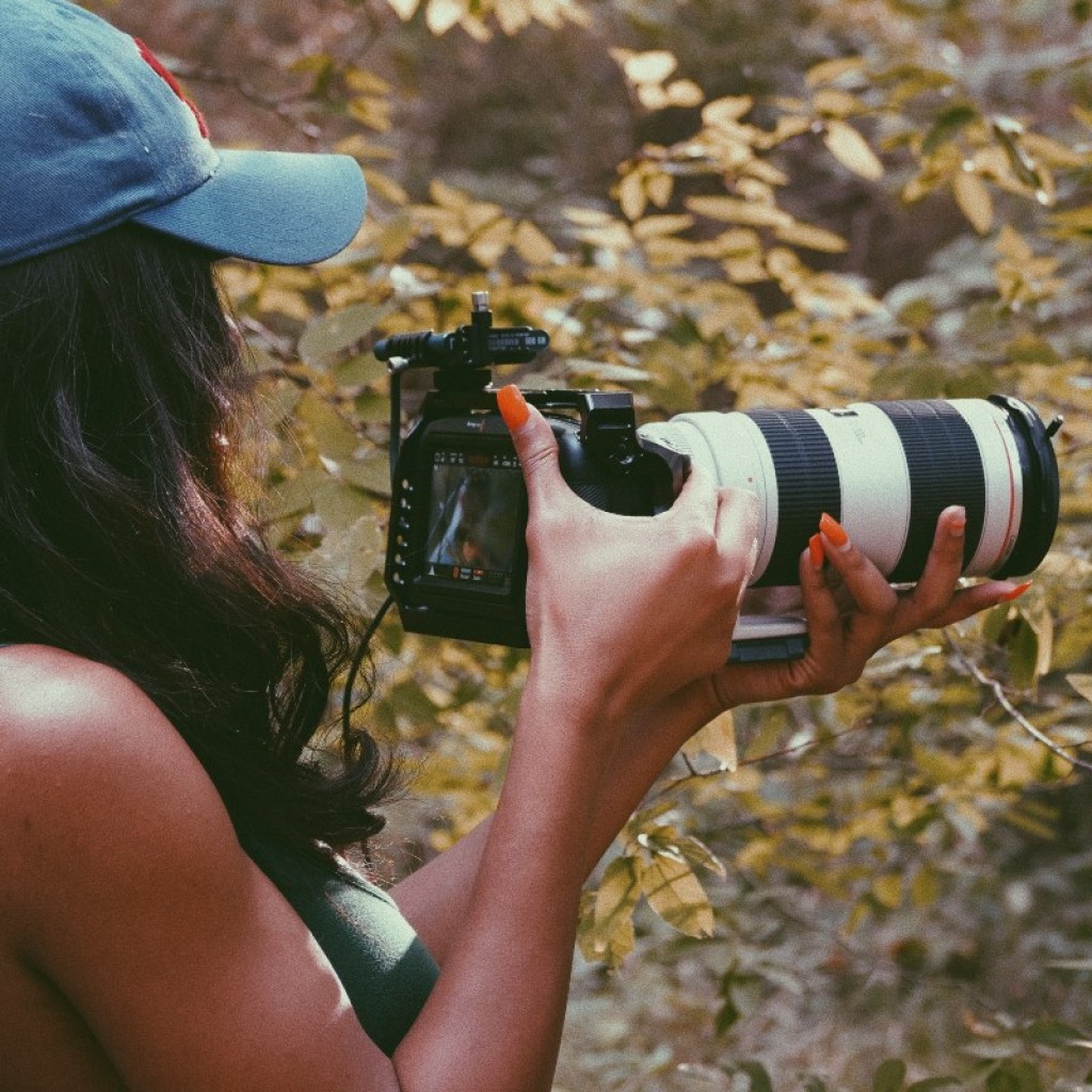 woman taking photos in woods