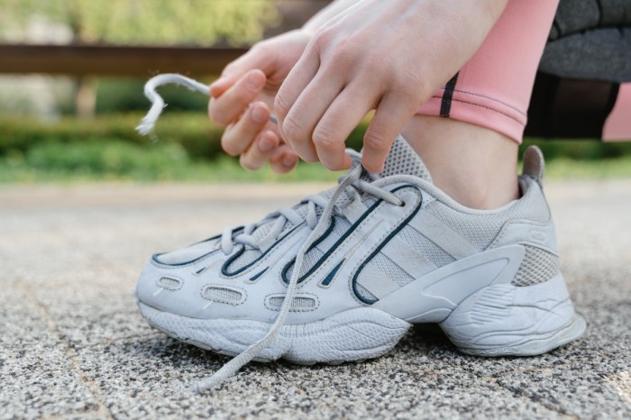 person tying shoelaces while outside