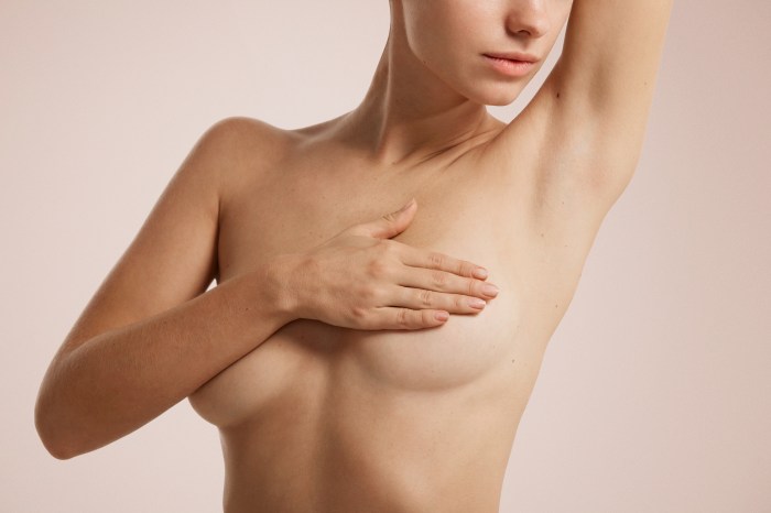 breast self examination woman with arm up examining