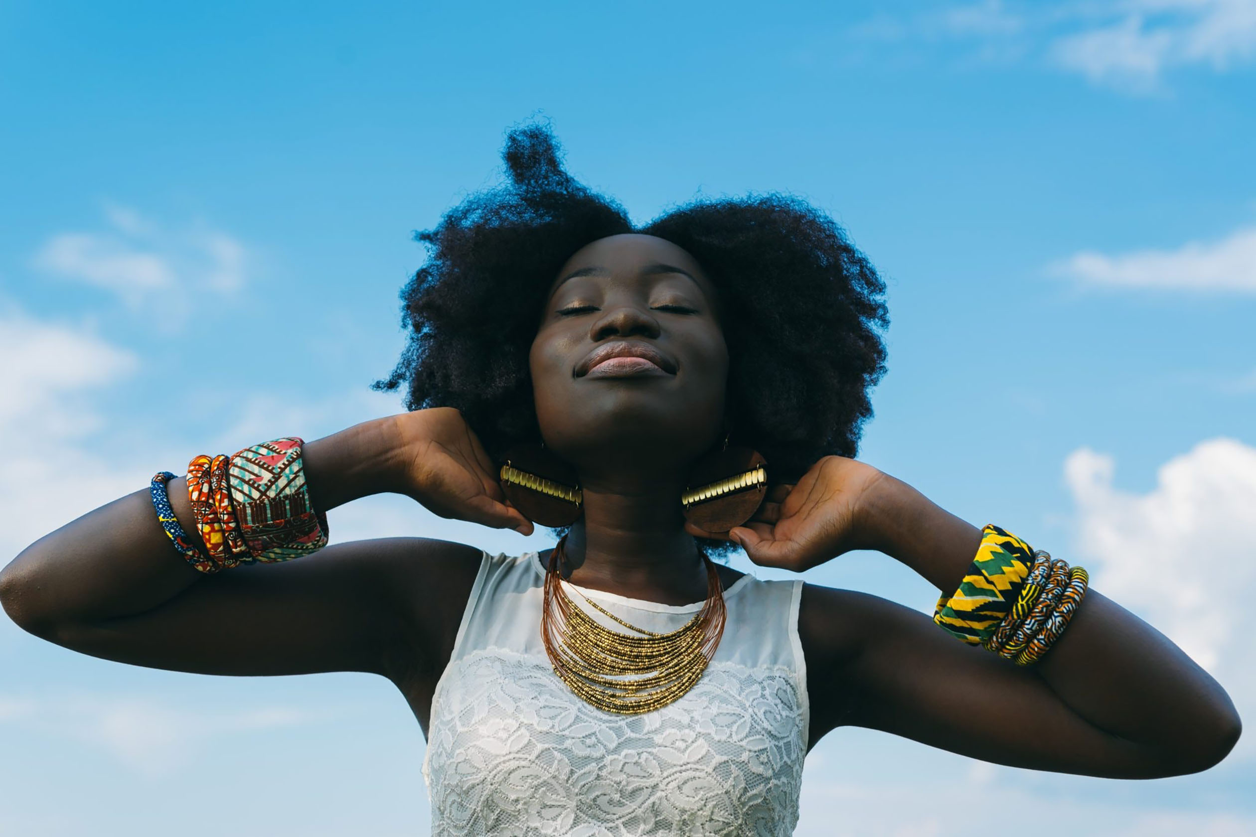 Happy woman wearing jewelry on a sunny day