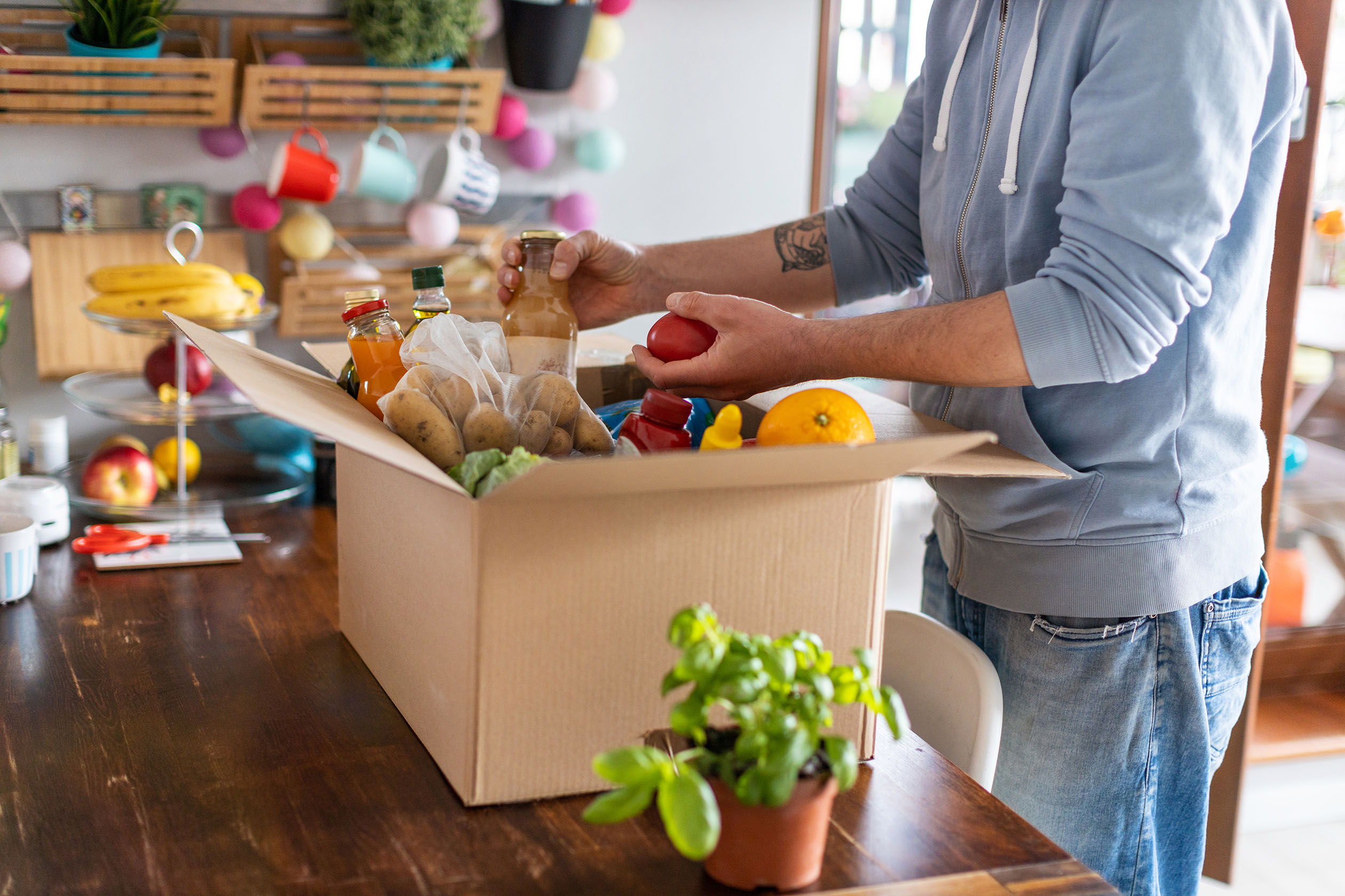 Man unpacking grocery delivery box