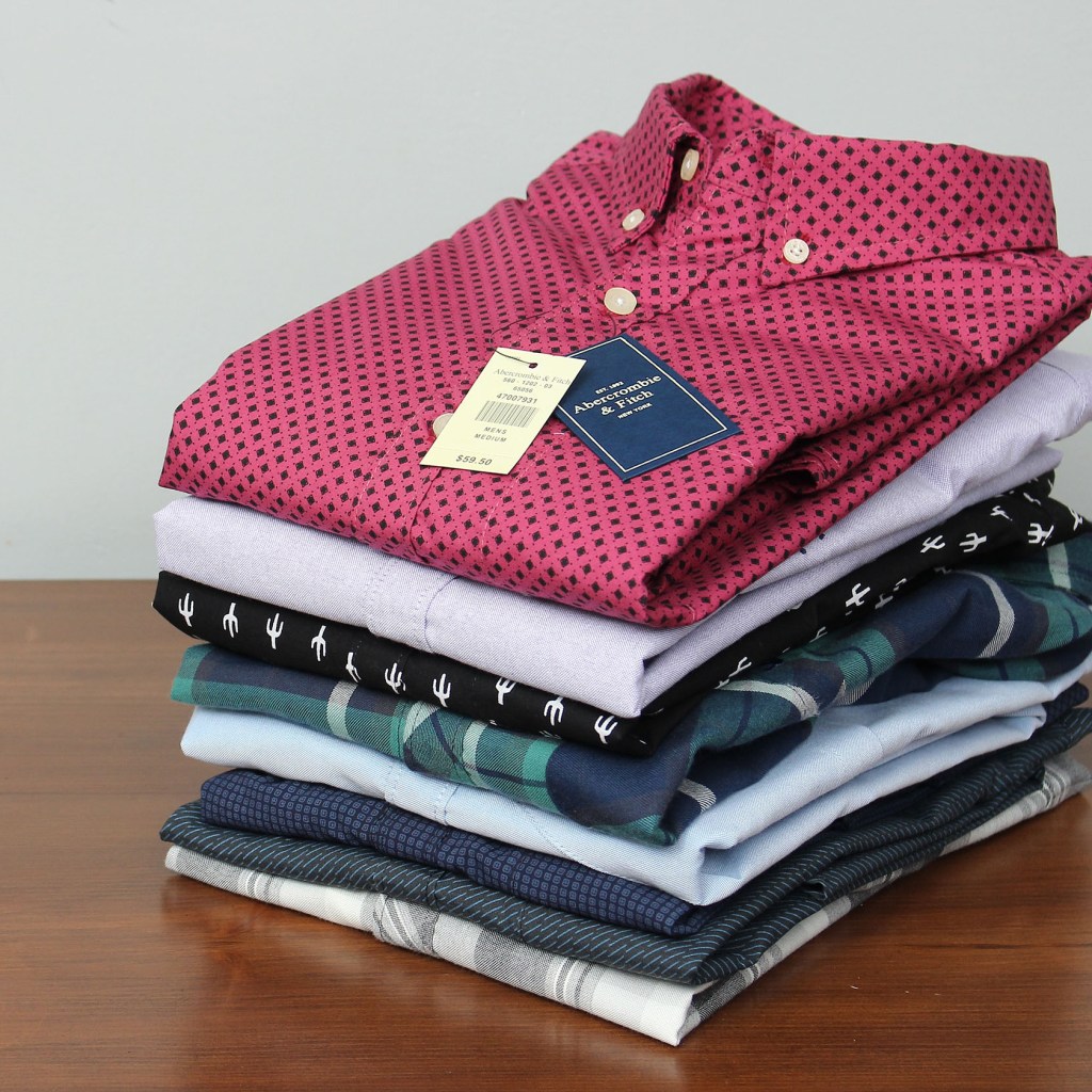 Pile of men's button-up shirts