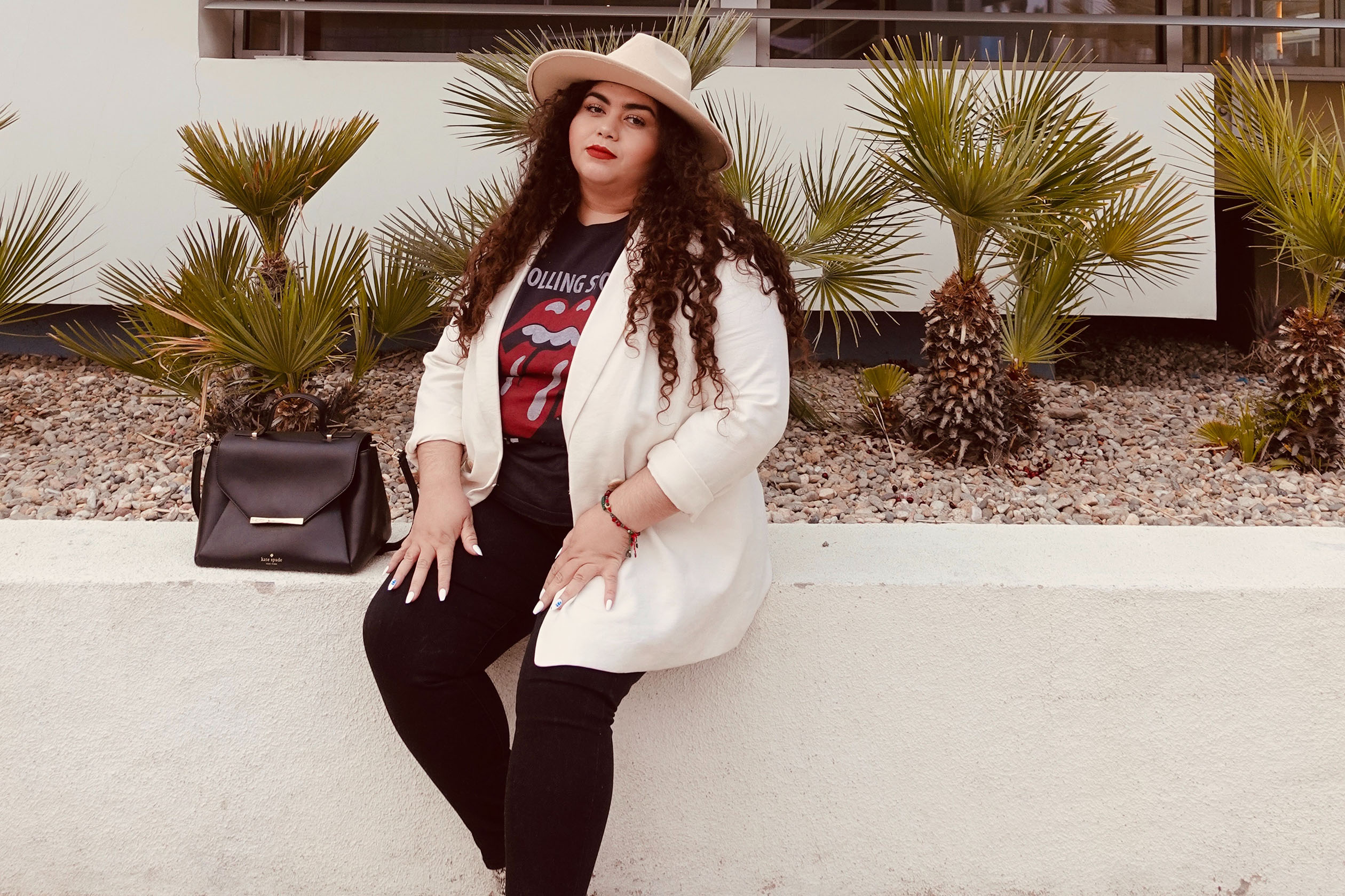 Plus-size woman wearing blazer and graphic tee