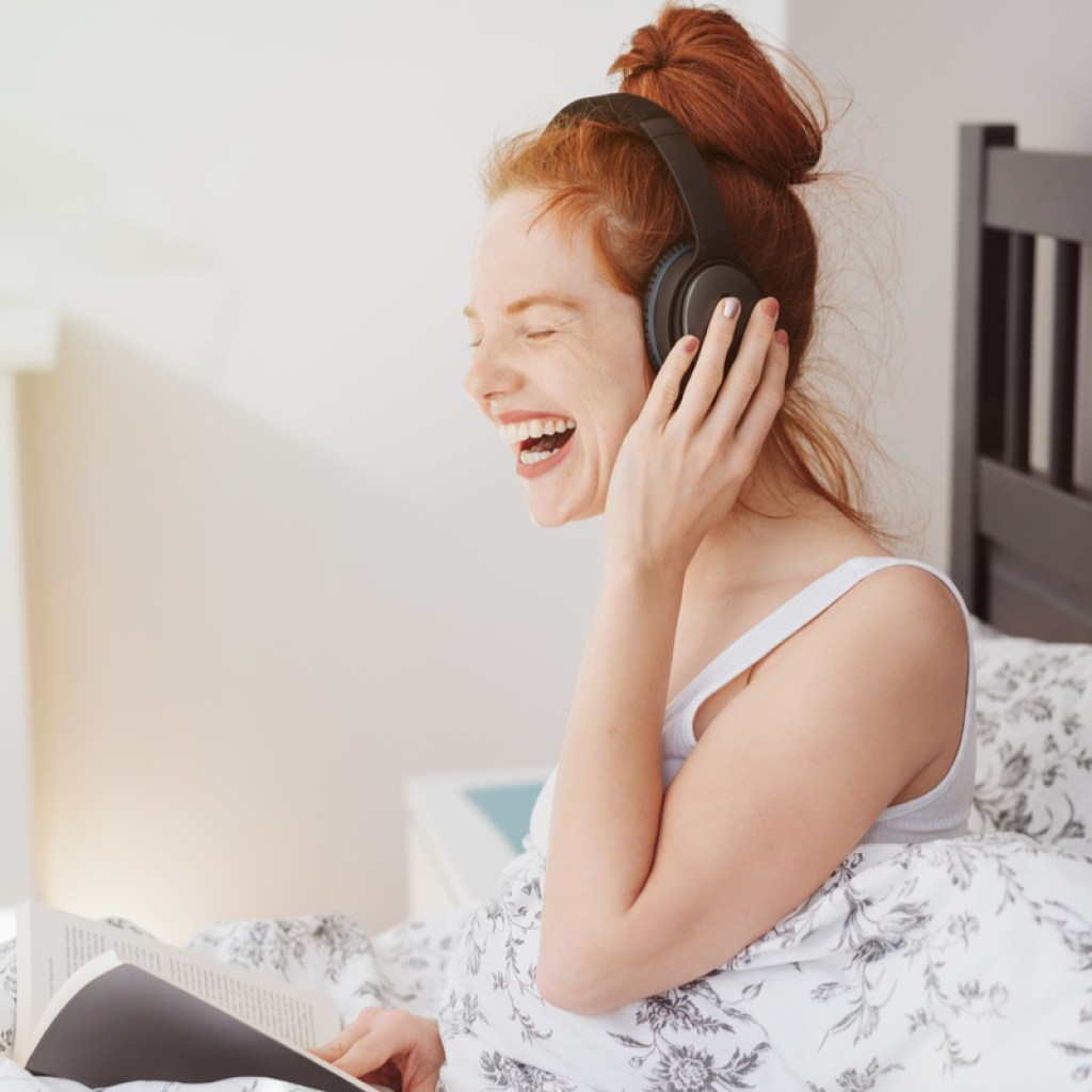 A woman listening to something funny.