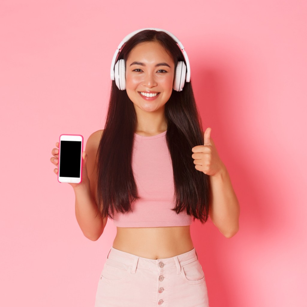 A woman listening to a podcast on her phone.