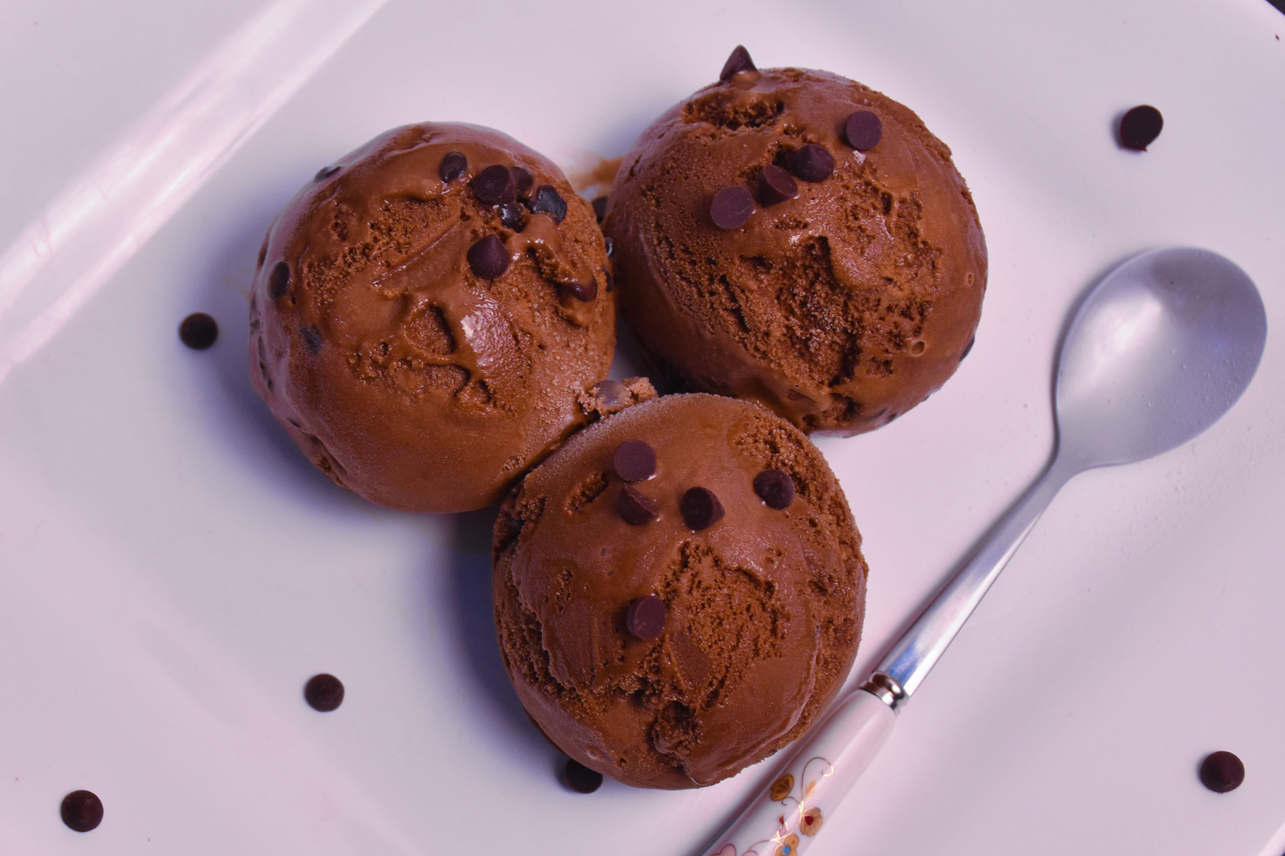 Three scoops of chocolate ice cream on a plate