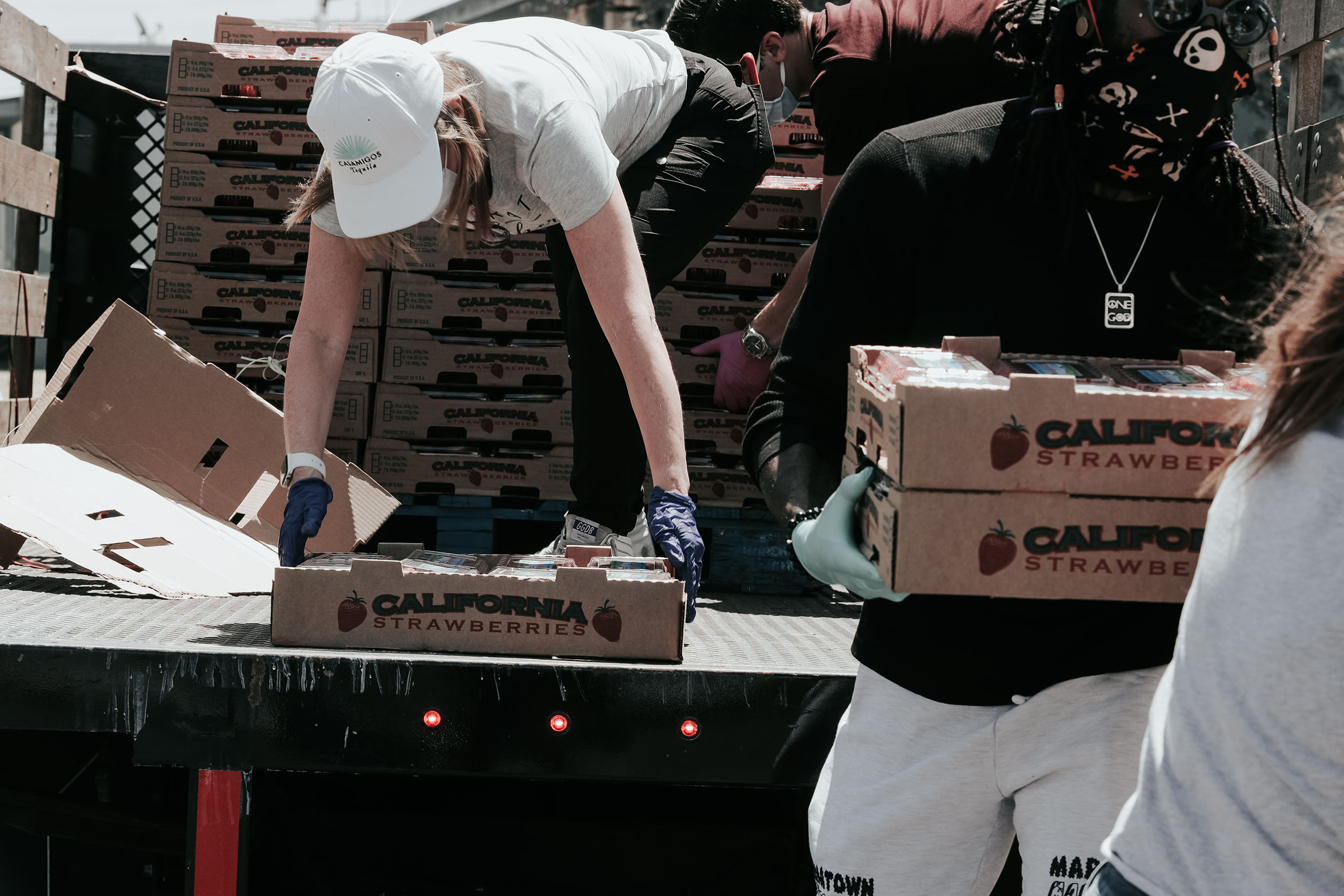 Volunteers unloading donated food from a truck