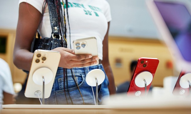 Woman looking at iPhone 13 at Apple store