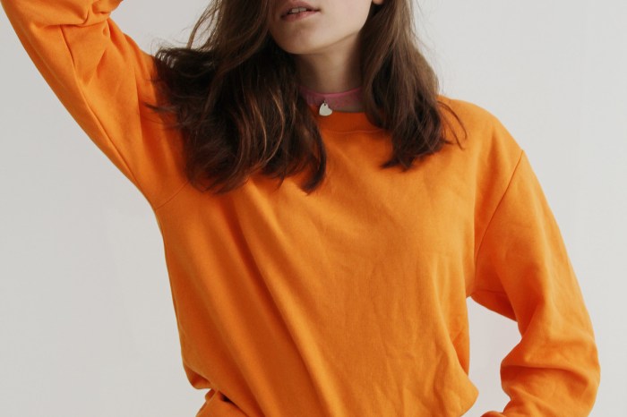 Woman wearing an orange long-sleeve shirt