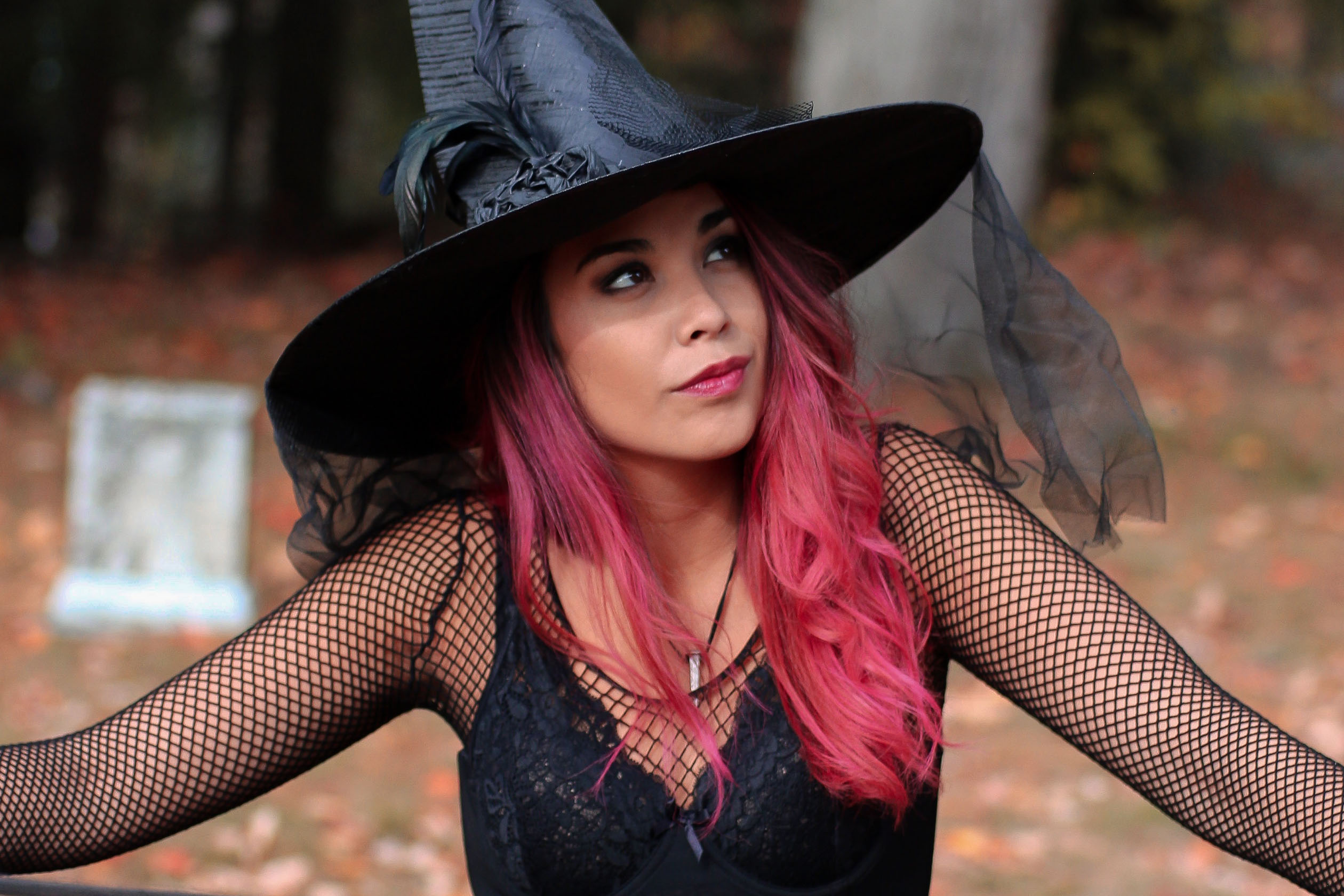 Woman with pink hair dressed as a witch