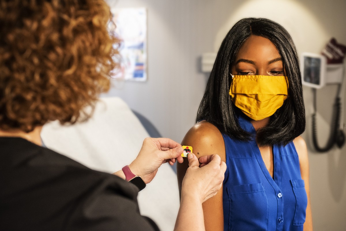 a woman receiving her covid-19 vaccine
