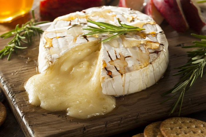 Baked brie on a wood cutting board