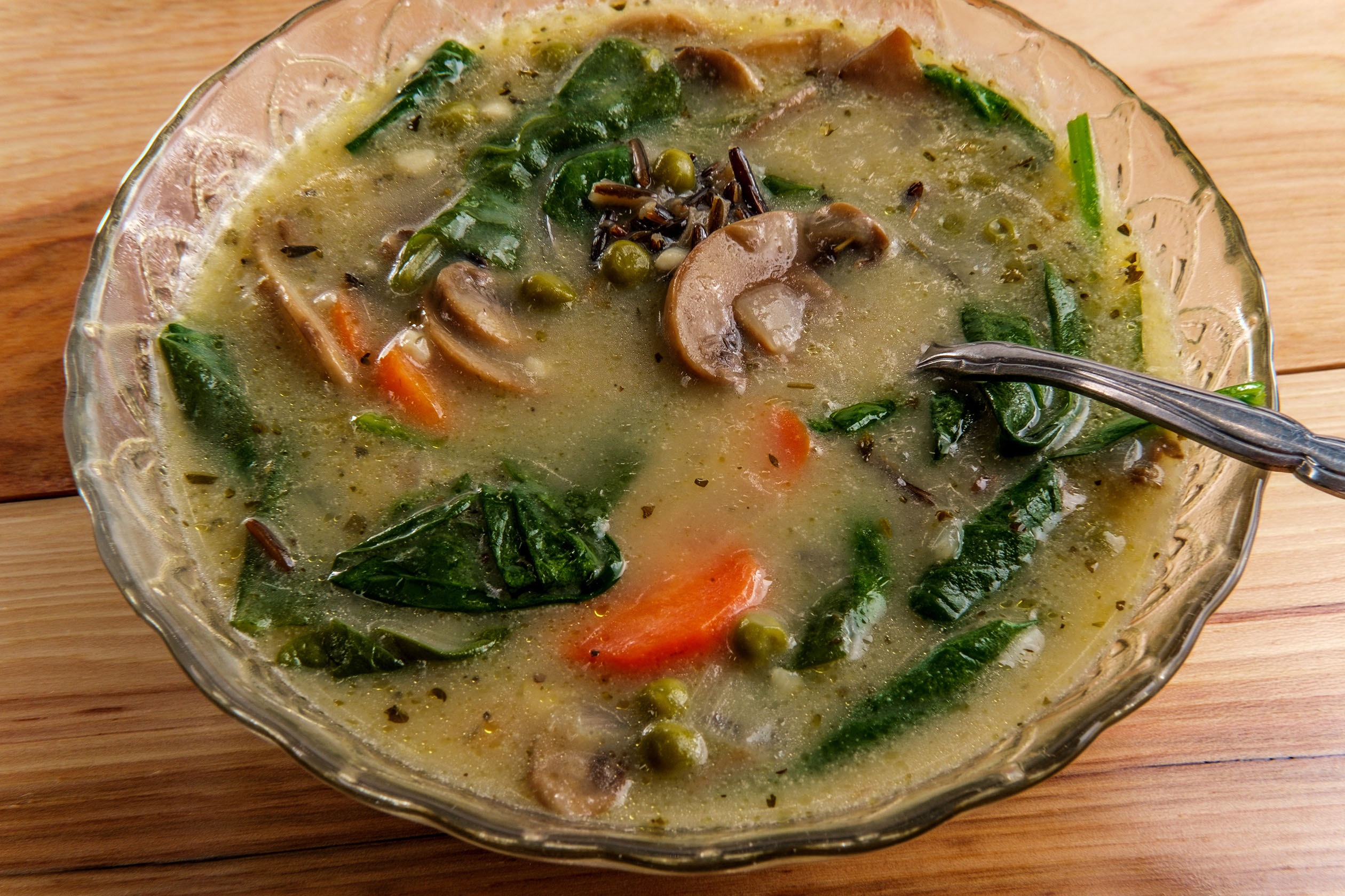Bowl of wild rice soup with mushrooms and spinach