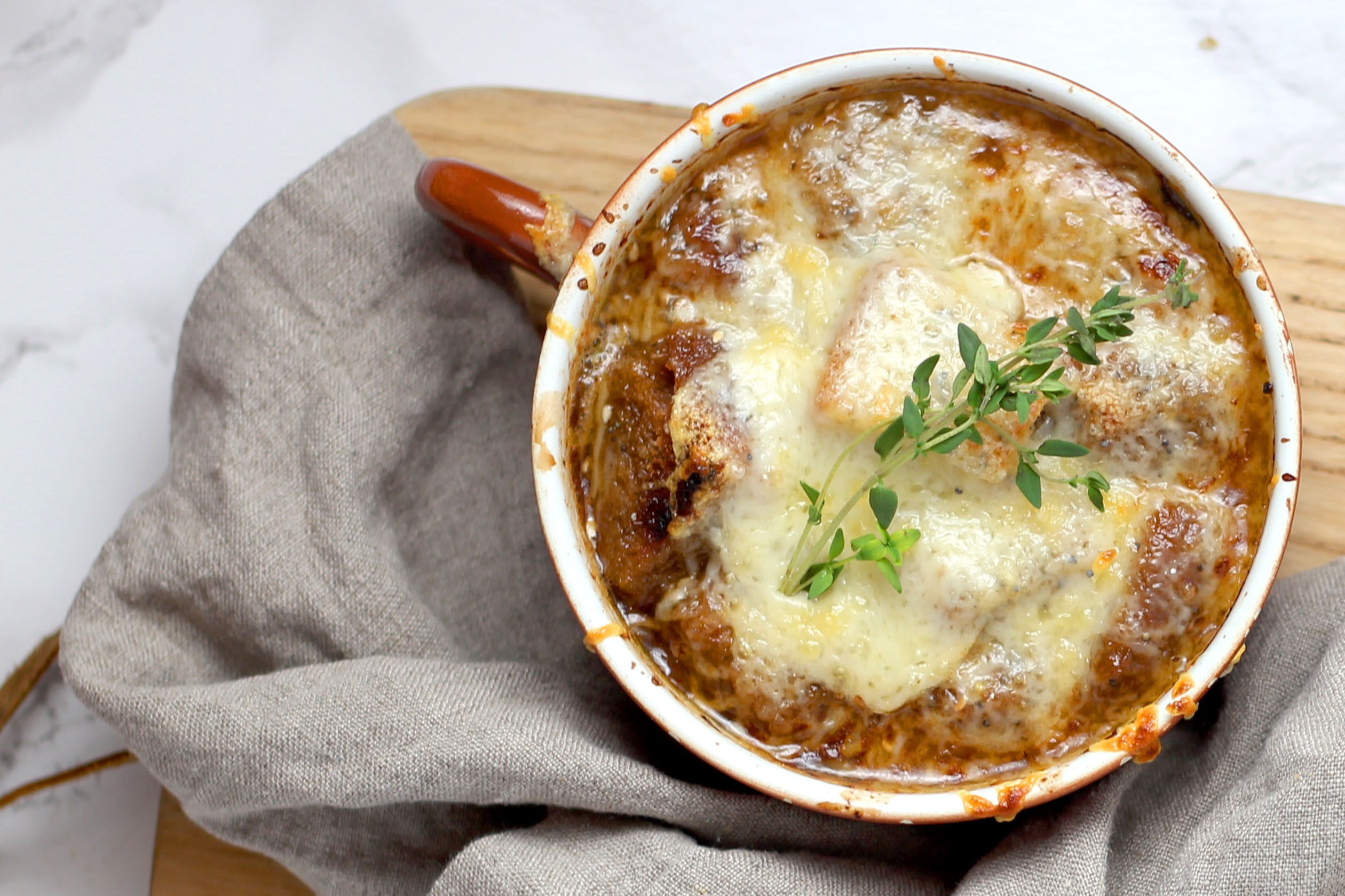 French onion soup on a wooden cutting board