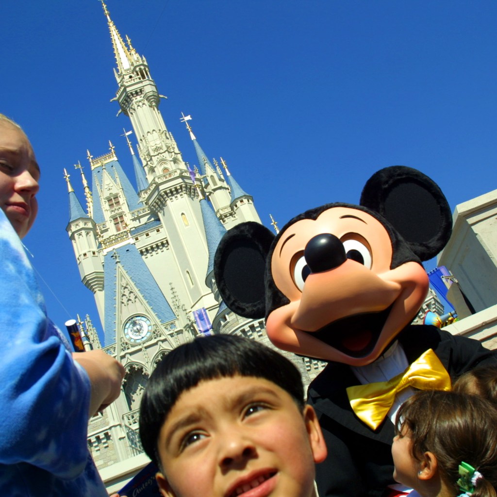 Close up of kids with Mickey Mouse at Disney World