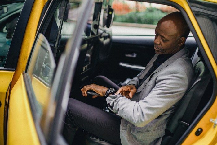 a man in a cab looking at his watch