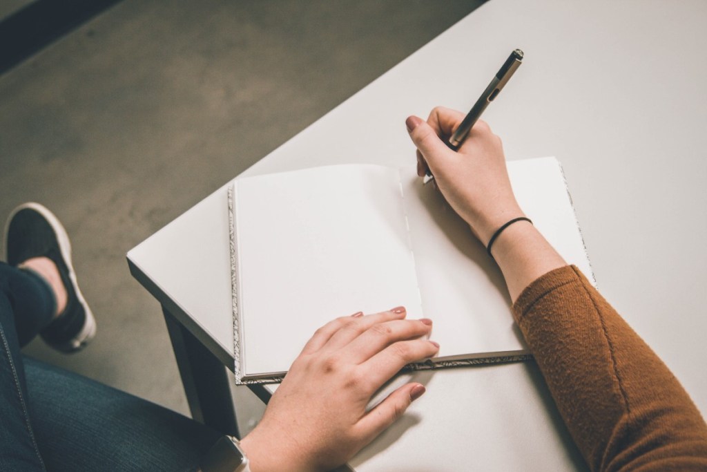 a person writing in a notebook