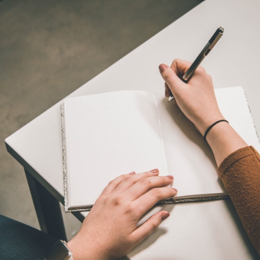 a person writing in a notebook