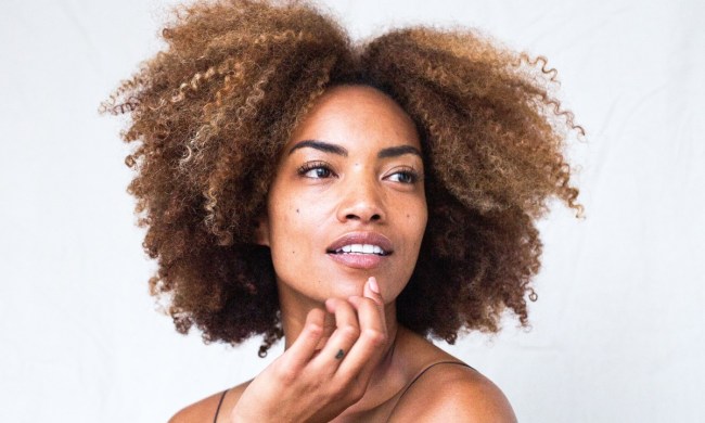 a beauty shot of a woman who is touching her chin