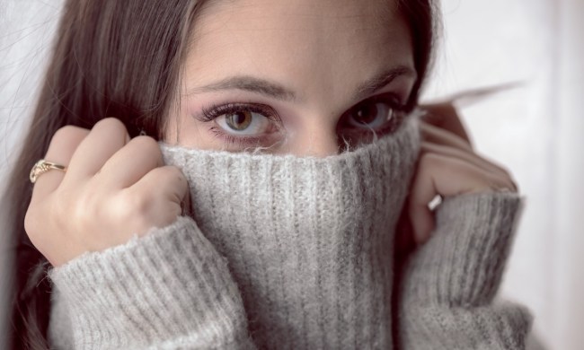 woman with a turtleneck pulled over her face