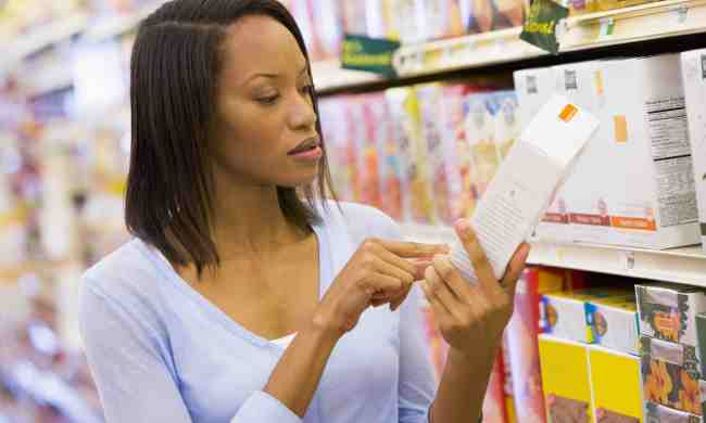 yuka app translates product labels woman reading food label