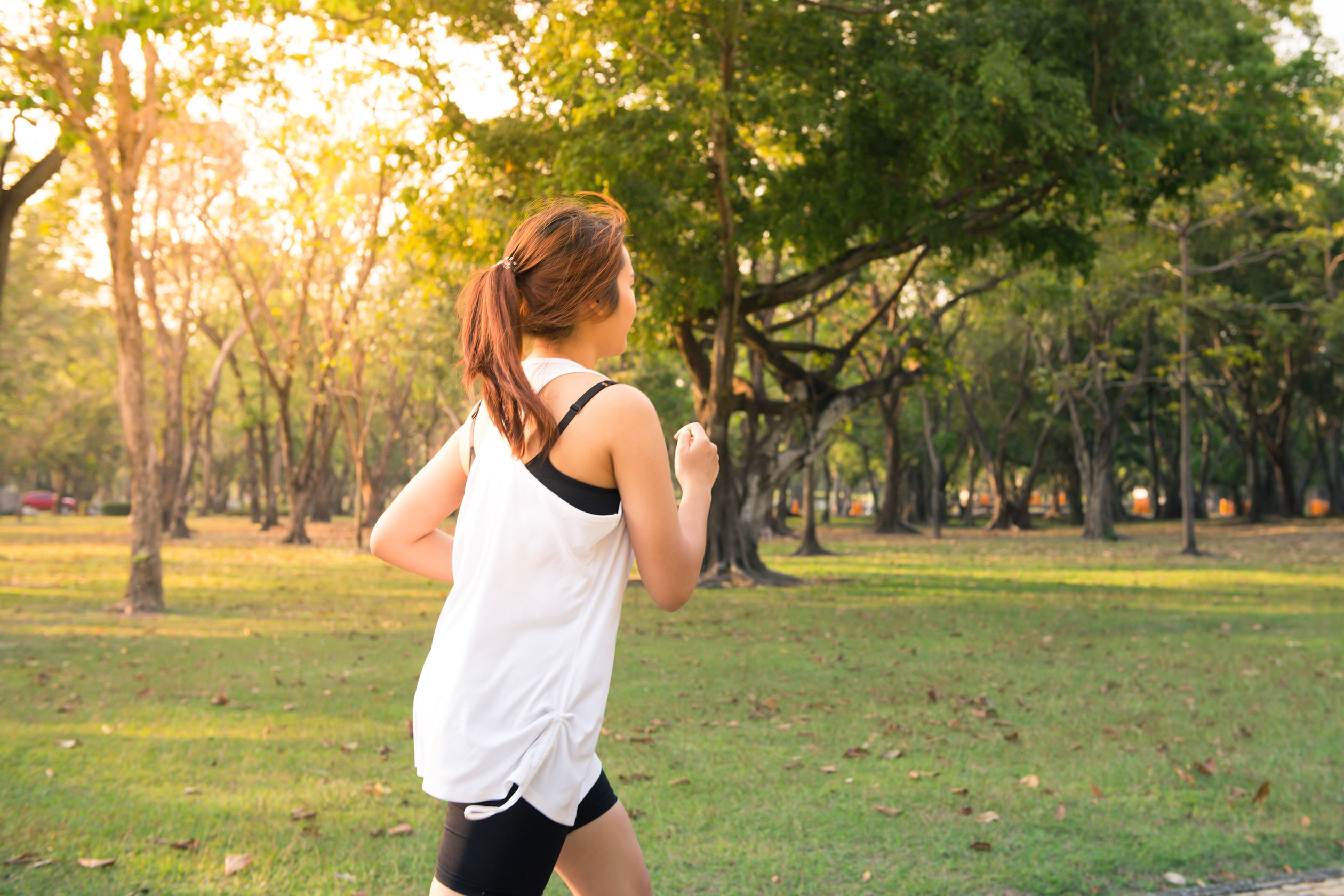 Woman running outside at sunset