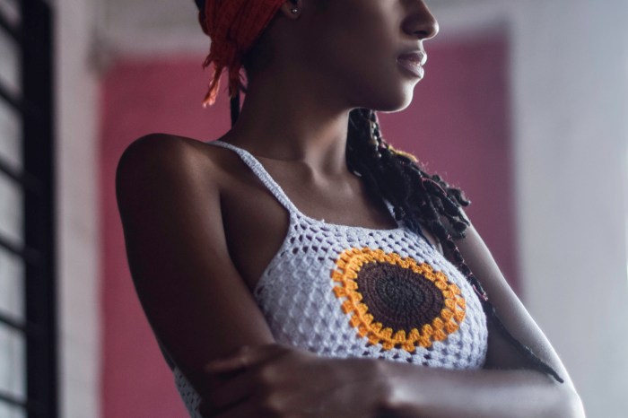 Woman wearing a crochet tank top with a sunflower on it