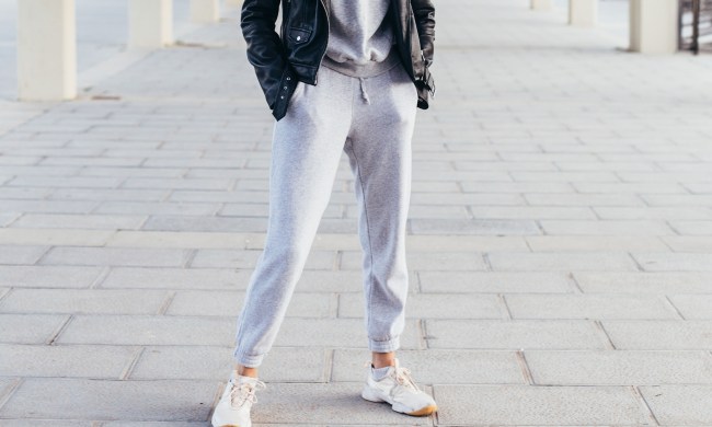 Woman wearing gray joggers with a sweatshirt and jacket