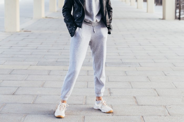 Woman wearing gray joggers with a sweatshirt and jacket