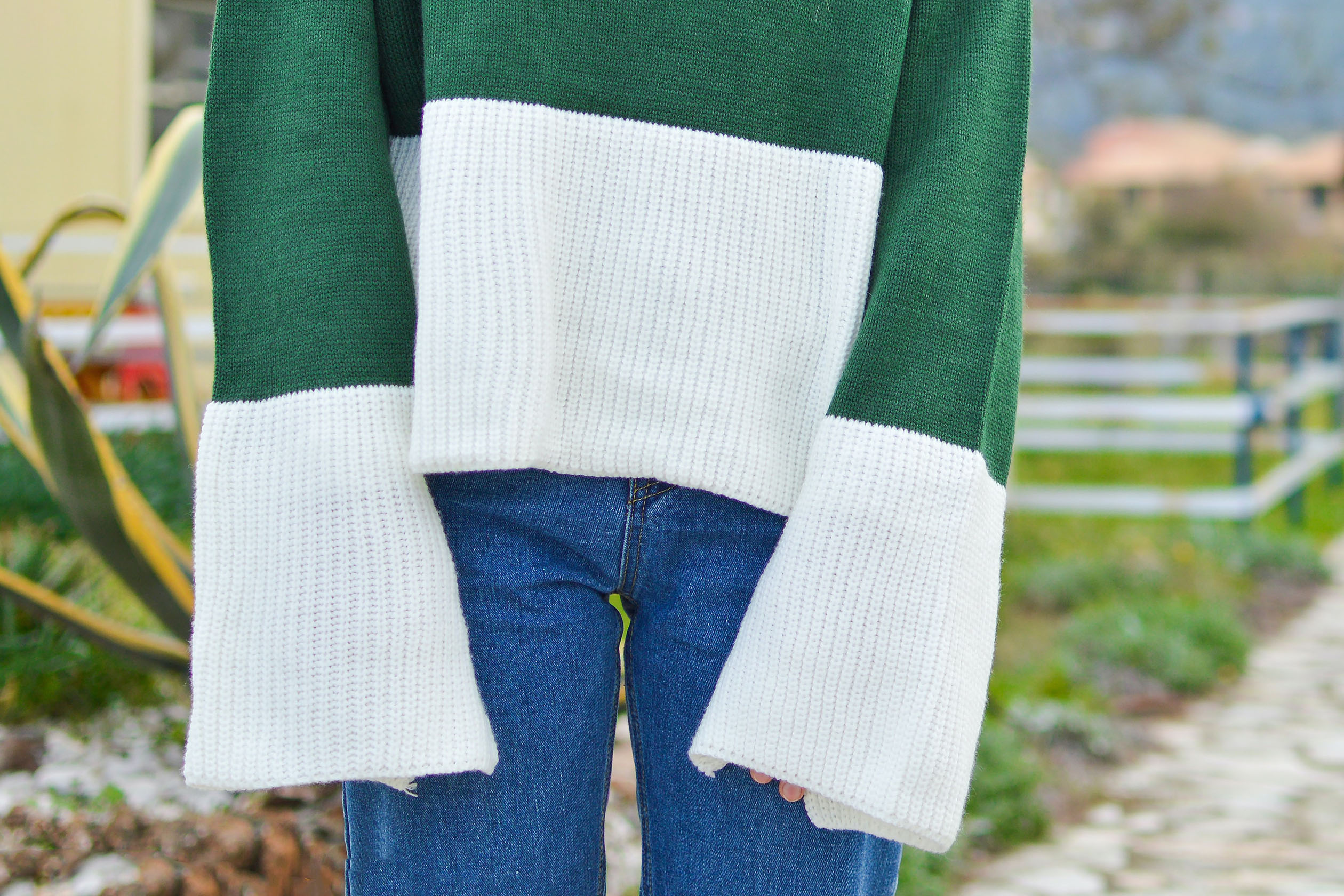Woman wearing green and white color block sweater
