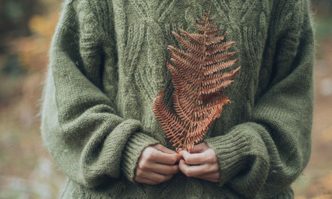 Woman wearing a green cable knit sweater