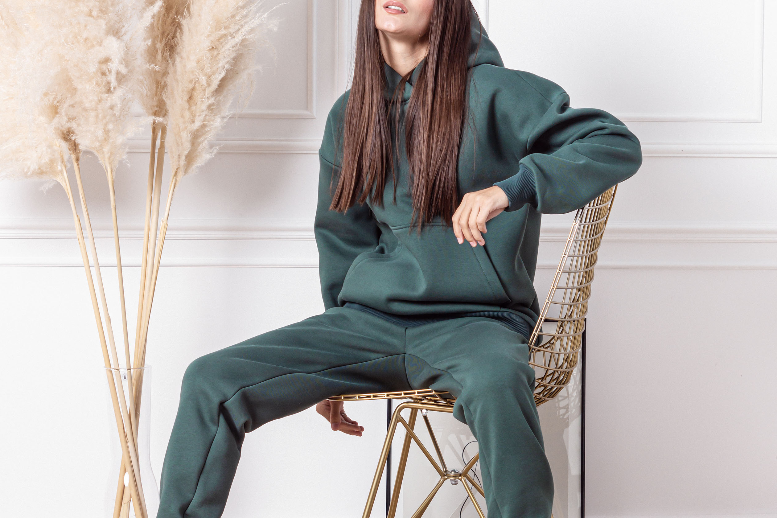 Woman wearing a dark green monochromatic sweatsuit