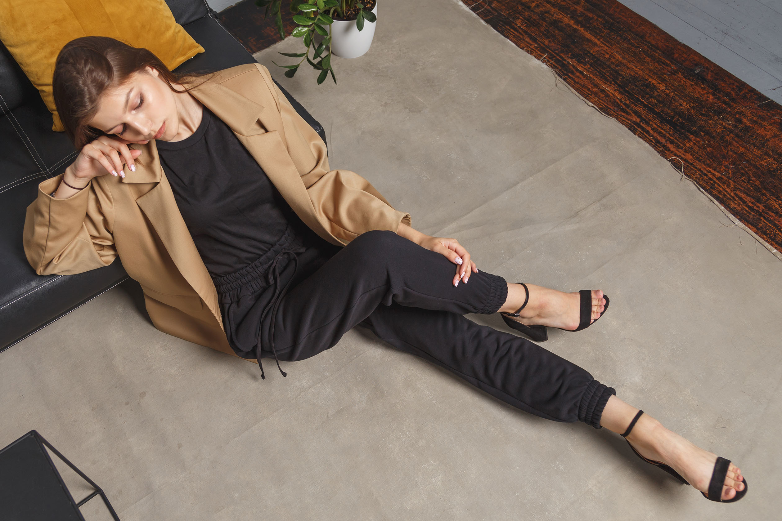 Woman wearing sweatpants, a blazer, and heels