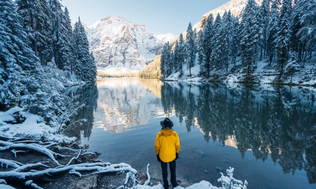 Man looking at lake and snow-covered moutnains