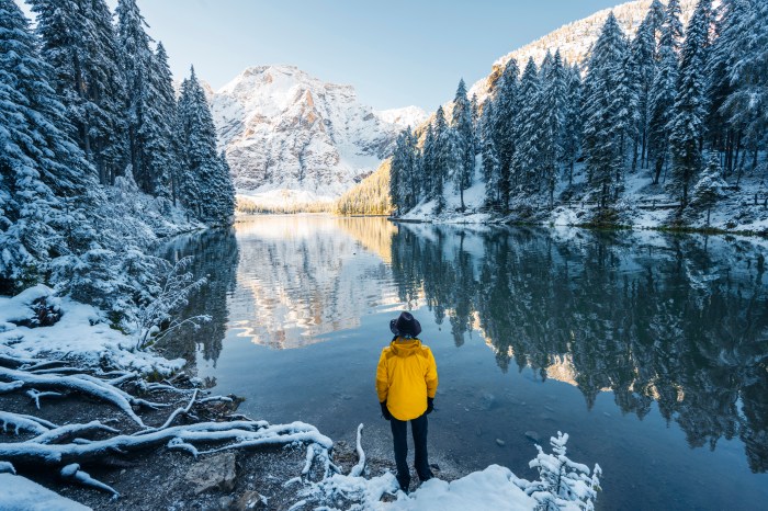 Man looking at lake and snow-covered moutnains